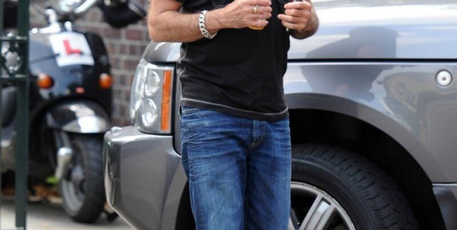 George Michael seen with an ice cool beverage as he arrives at a studio on a hot summer's day in London.