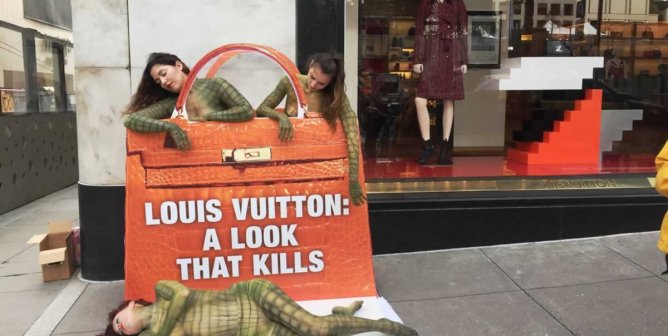 Body-painted "reptiles" outside Louis Vuitton San Francisco store