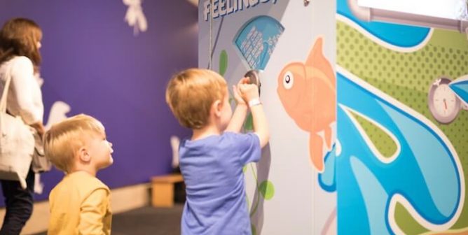 Children interacting with "Fish Have Feelings, Too" display in TeachKind's Destination: Empathy exhibit