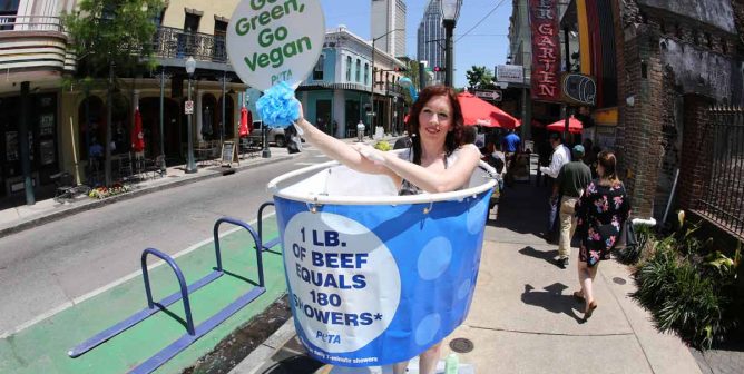 activist in the shower on a sidewalk - a peta earth day protest in mobile
