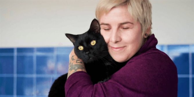 PETA fieldworker with black cat