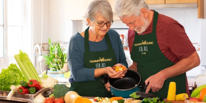 An older couple makes vegan food together