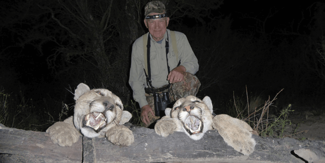 hunter in argentina displays two pumas