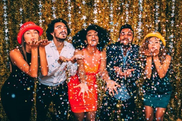 new year party of five people celebrating with confetti