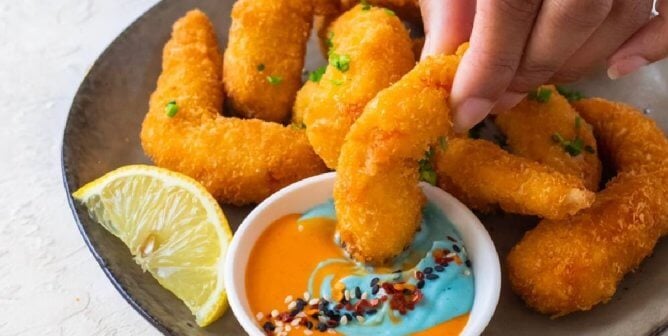 breaded vegan shrimp from vegan zeastar on a plate with a dipping sauce