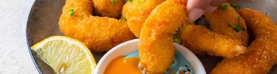 breaded vegan shrimp from vegan zeastar on a plate with a dipping sauce