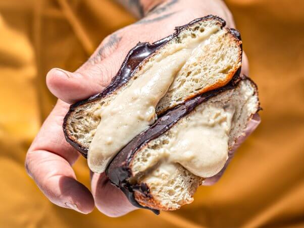 hand holding a vegan Boston Dream donut from Level 5 Donuts