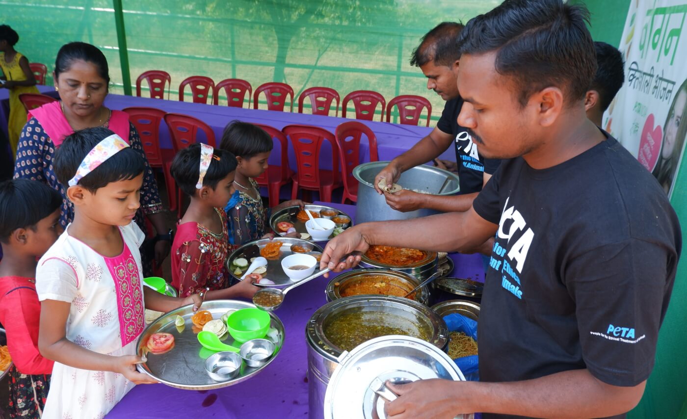PETA India staff serving food to children