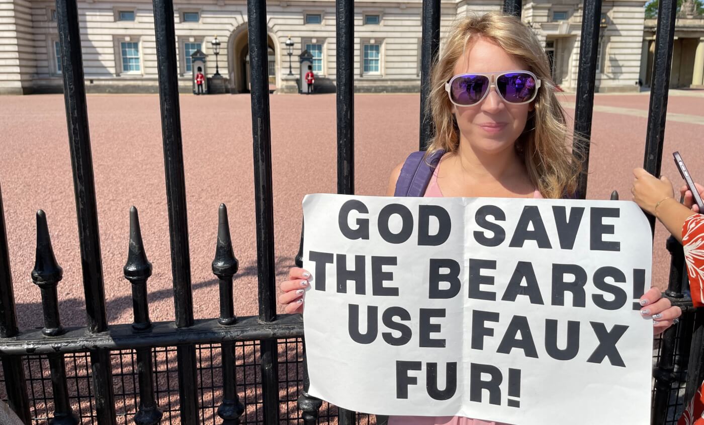 PETA staffer Michelle holds a sign that reads, "GOD SAVE THE BEARS! USE FAUX FUR!"