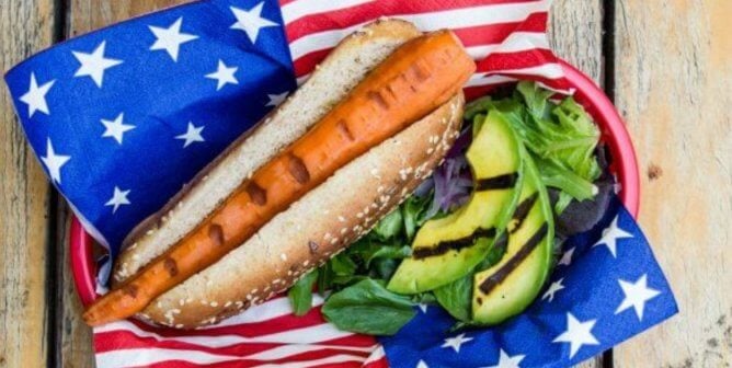 vegan carrot dog with avocado salad and flag napkin