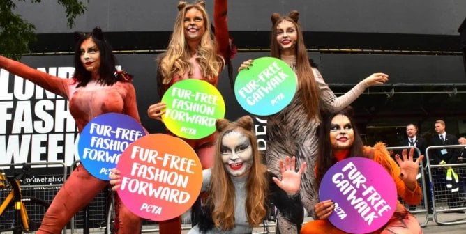 Women in cat suits protest fur at London Fashion Week