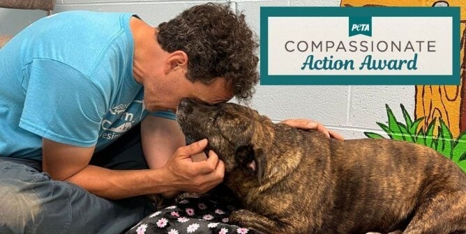 man holding dog and compassionate action award
