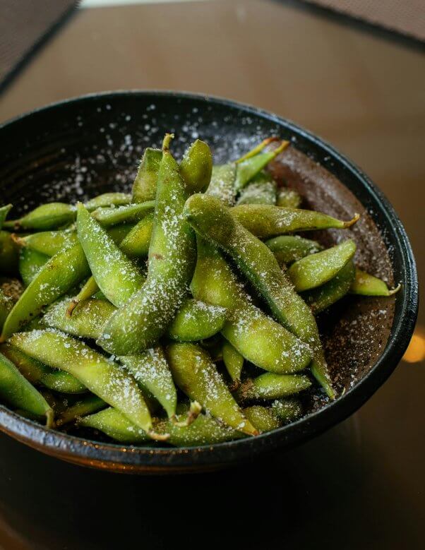 a bowl of salted edamame