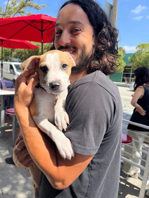 man holding puppy at monty's good burger PETA event