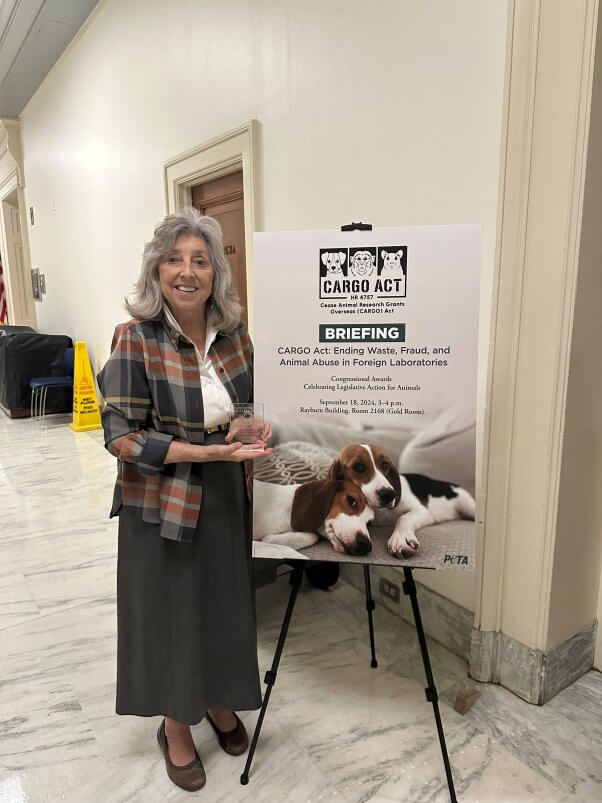 Reps. Dina Titus next to a Cargo Act briefing poster