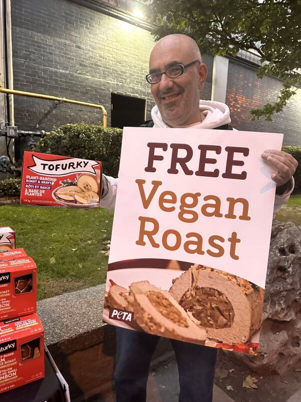 passersby recieving vegan turkeys at a PETA giveaway in Ontario, Canada