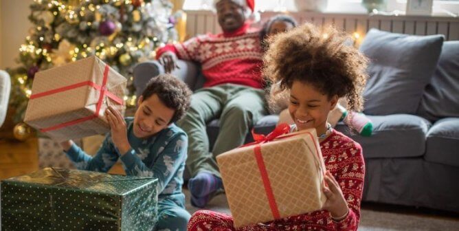 Children opening holiday gifts