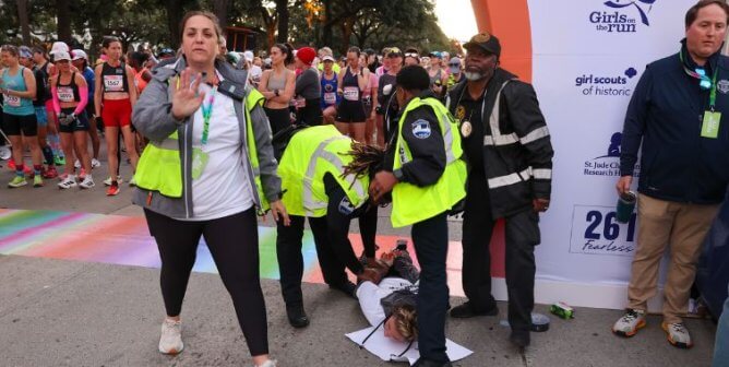 Person holding up their hand as a demonstrator is arrested