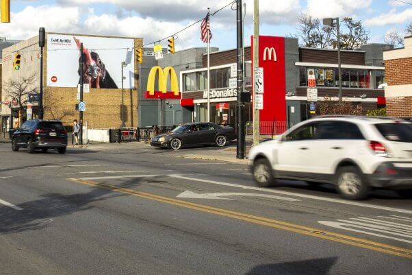 Photo of billboard next to a McDonald's featuring a chicken looking at the viewer with text reading I'm ME not Meat