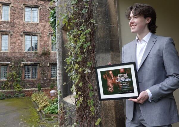 Callan MacDonald holding framed award