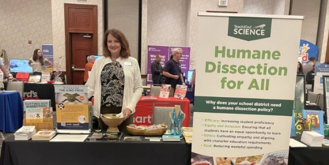 A person standing at Teachkind's table