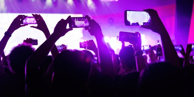 people taking pictures at a concert