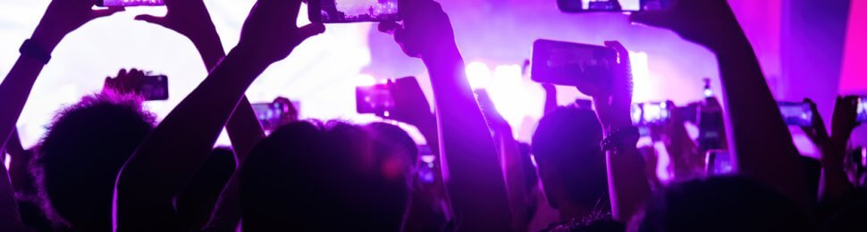 people taking pictures at a concert