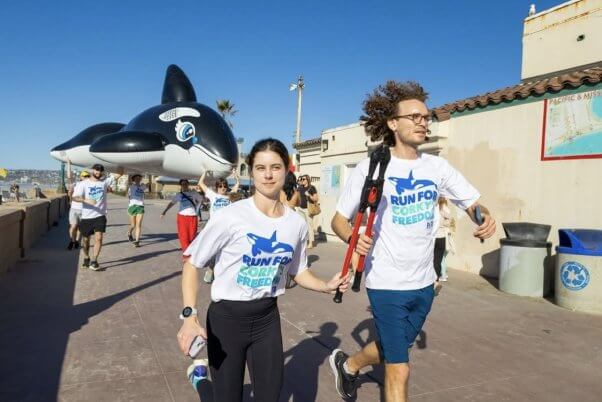 two people holding bolt cutters and running 