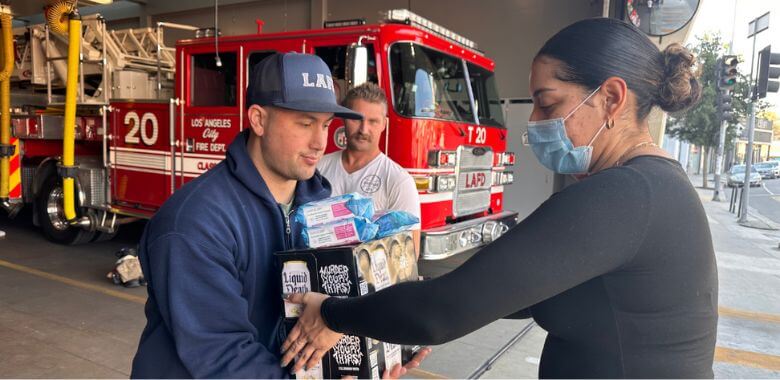 PETA volunteer donating items to LA fire department