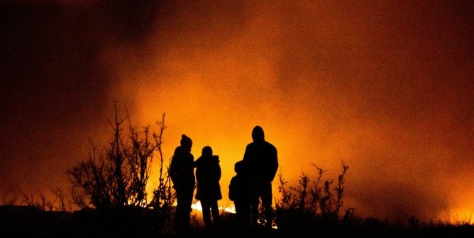 silhouette of a family watching a wildfire