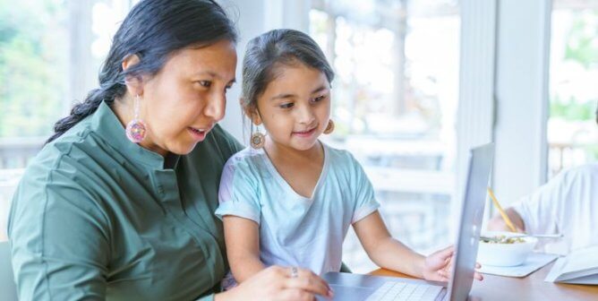 A mom and her daughter at a computer