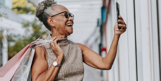 A older woman taking a selfie while shopping